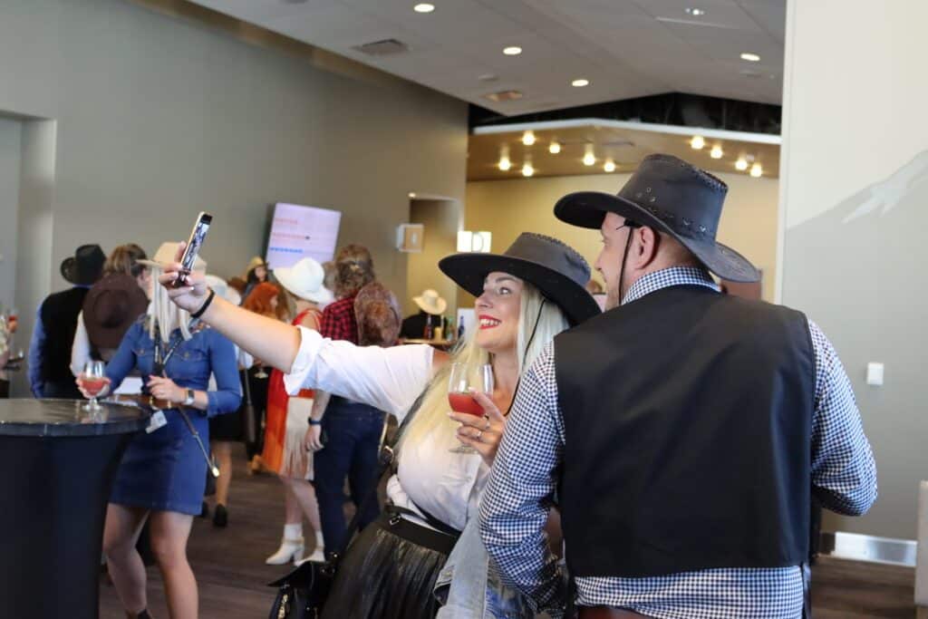 woman and a man in western wear taking a selfie