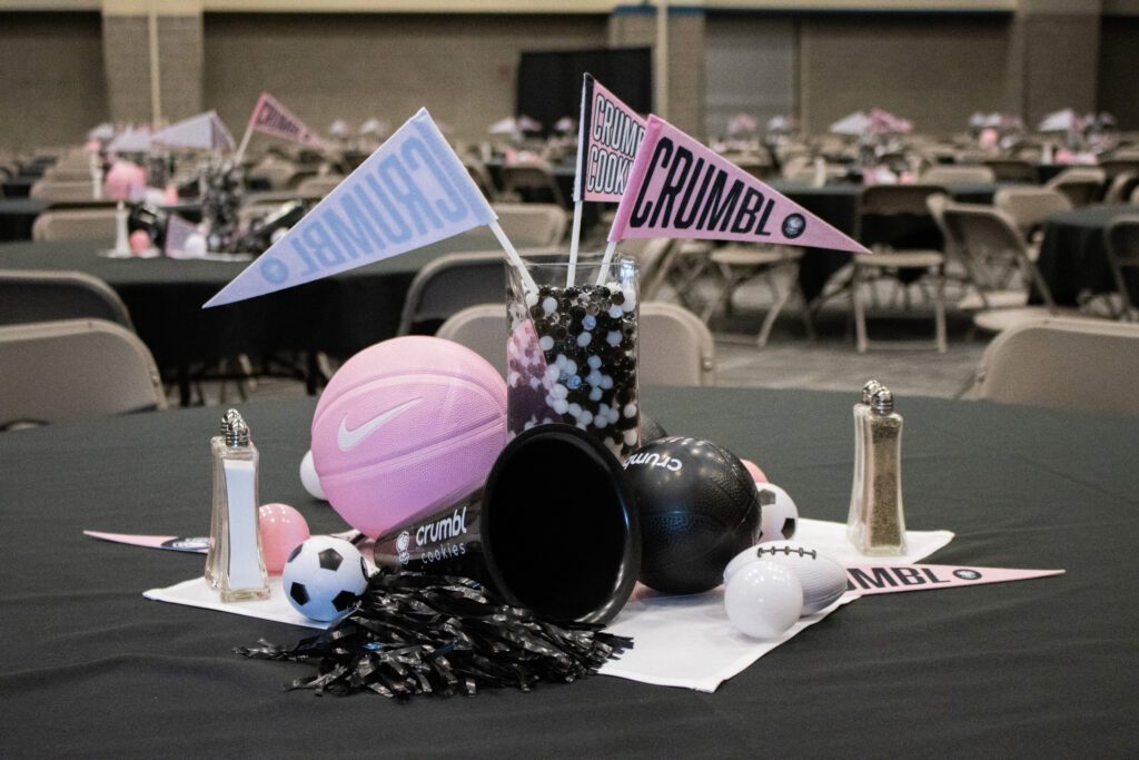 sports balls and Crumbl cookies branding at an event