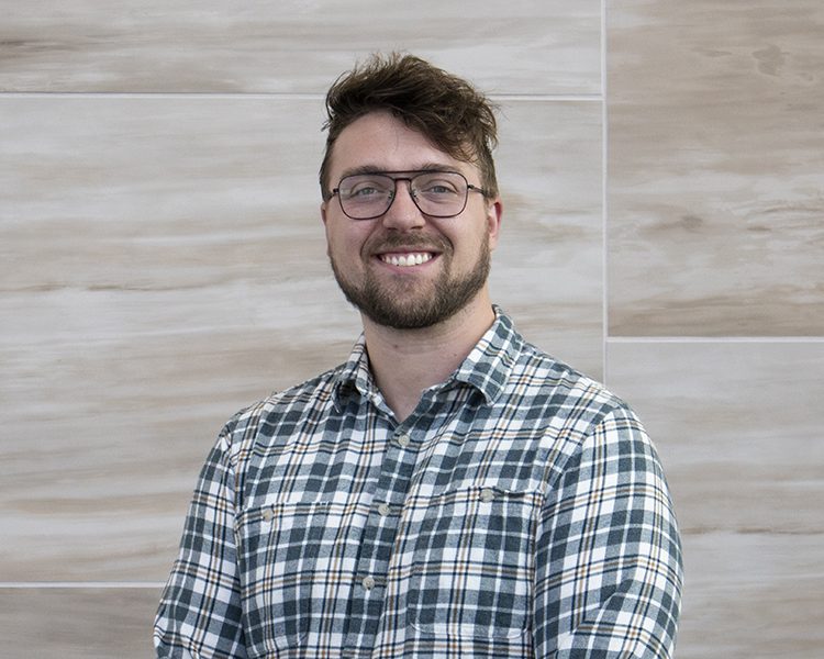 smiling man in plaid button up shirt